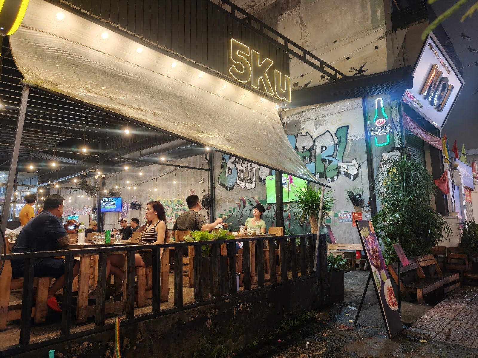 Meat grilling over charcoal at 5ku Station