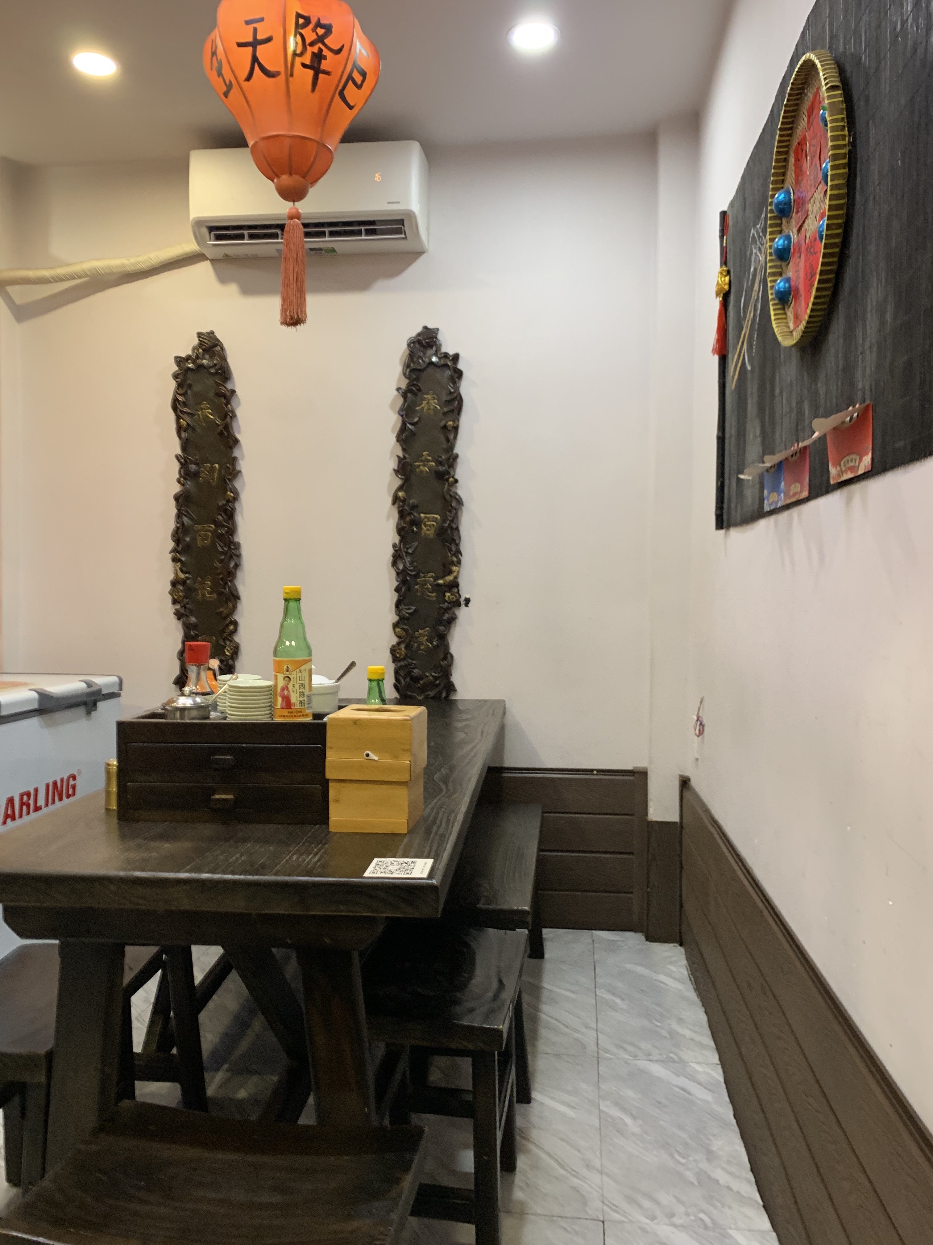 Wooden table corner with the orange paper lantern