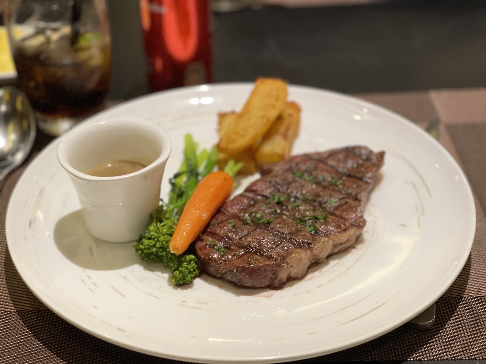 Grilled steak with vegetables and a sauce cup on the side (diner photo by Cong Thuan Tran, Dec 2025)