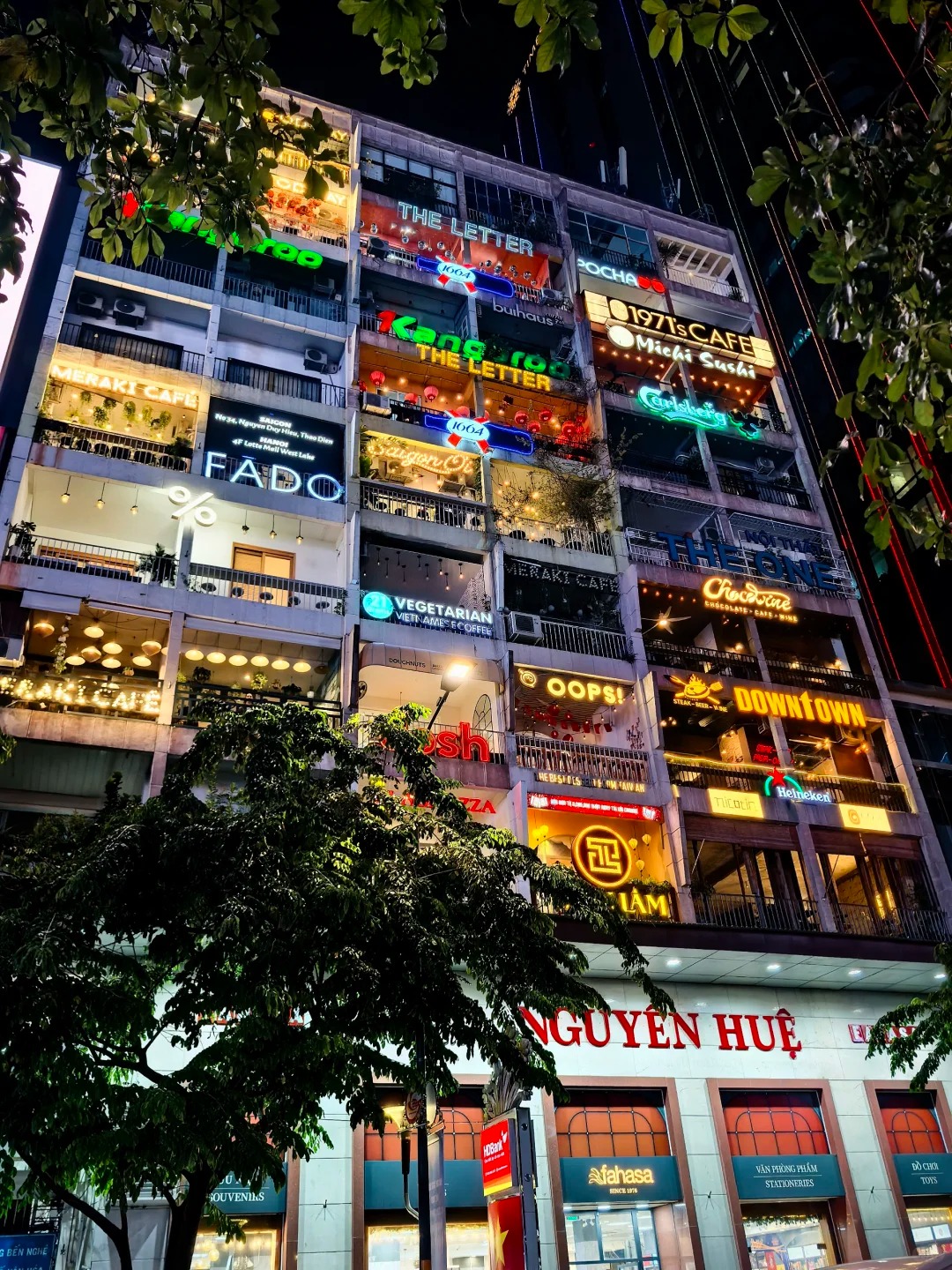 Mặt tiền chung cư 42 Nguyễn Huệ về đêm với bảng neon Saigon Ơi