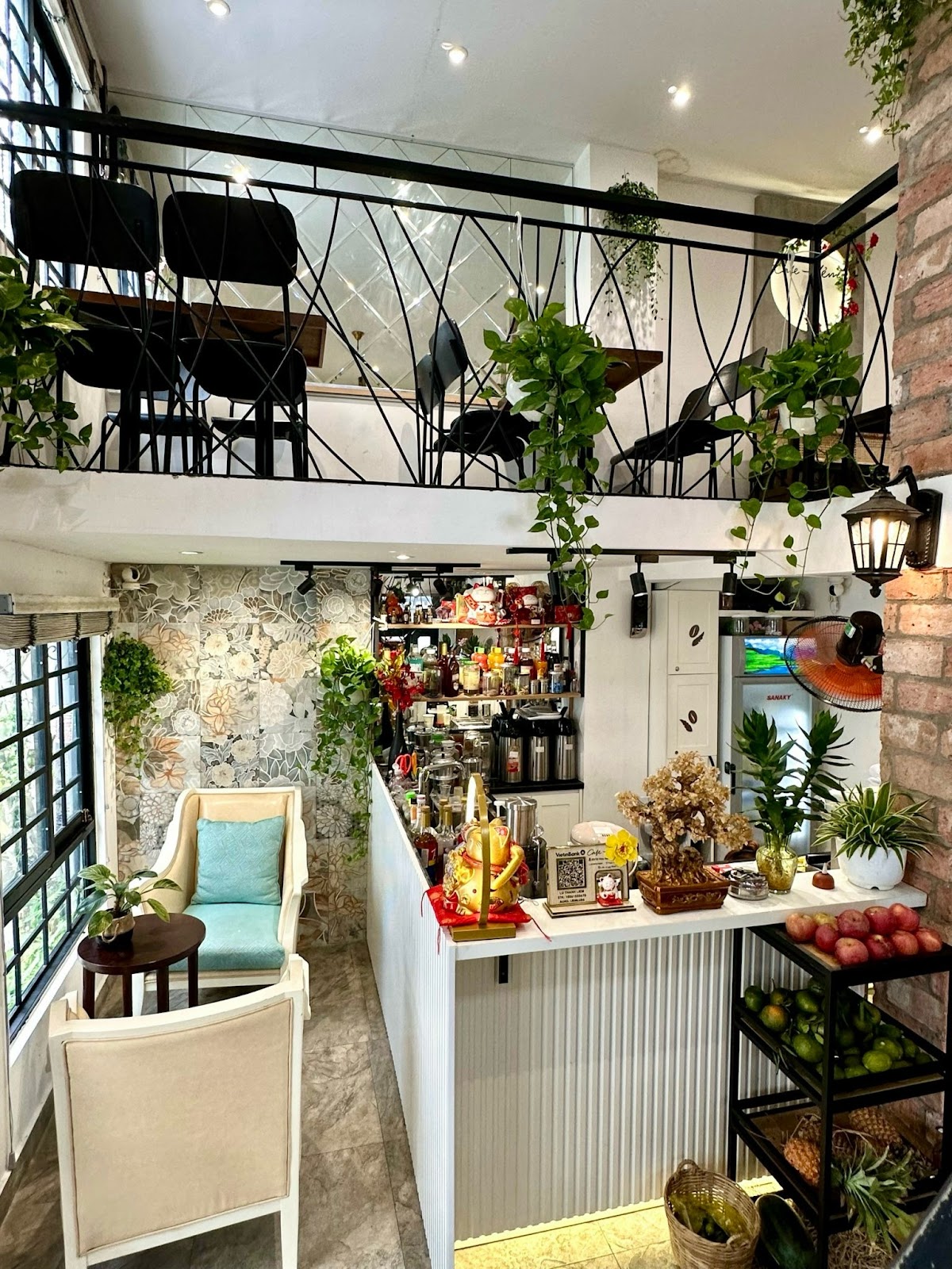 the brew bar by the brick pillar with the mezzanine above