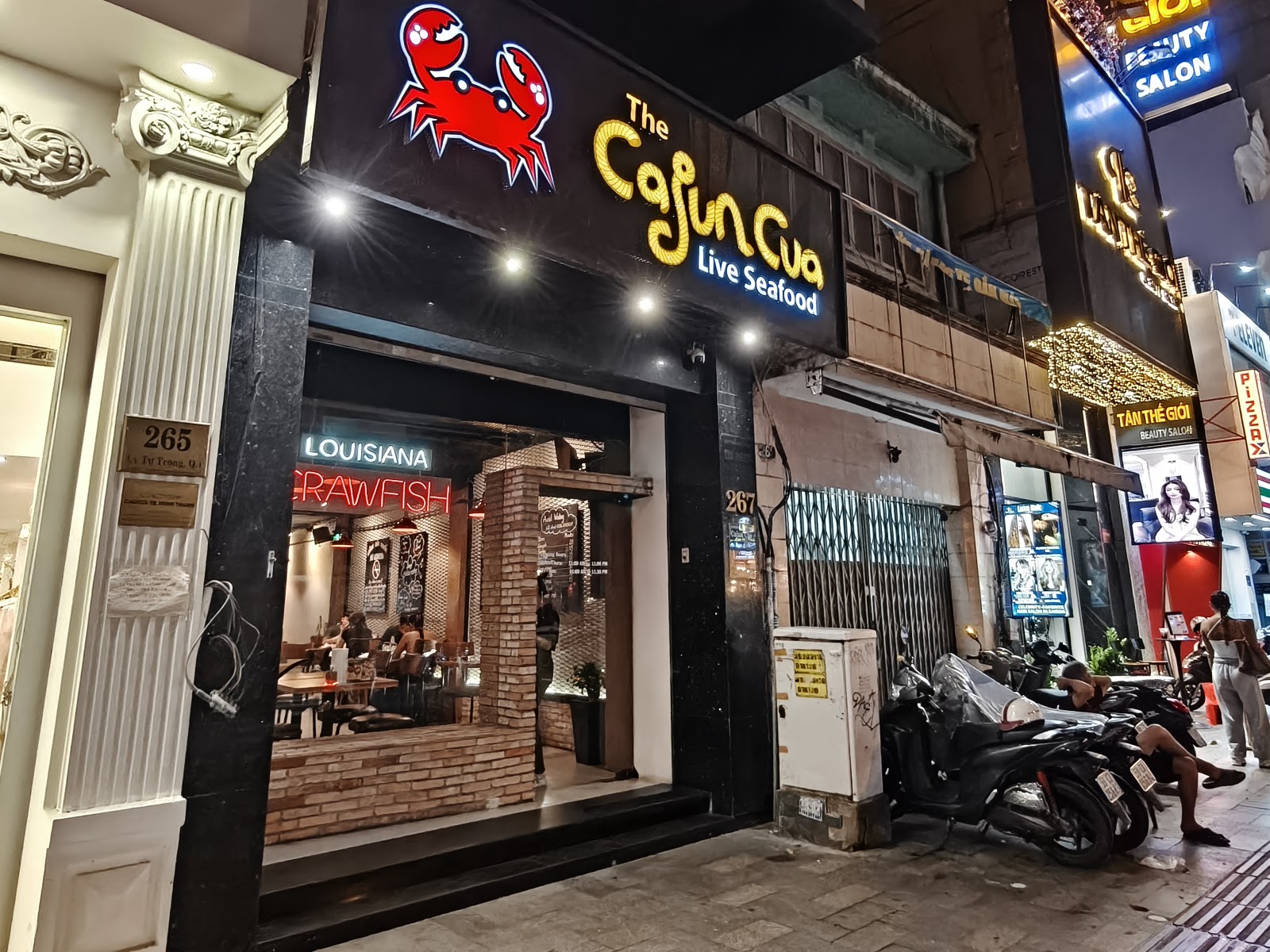 The Cajun Cua storefront at night on Lý Tự Trọng