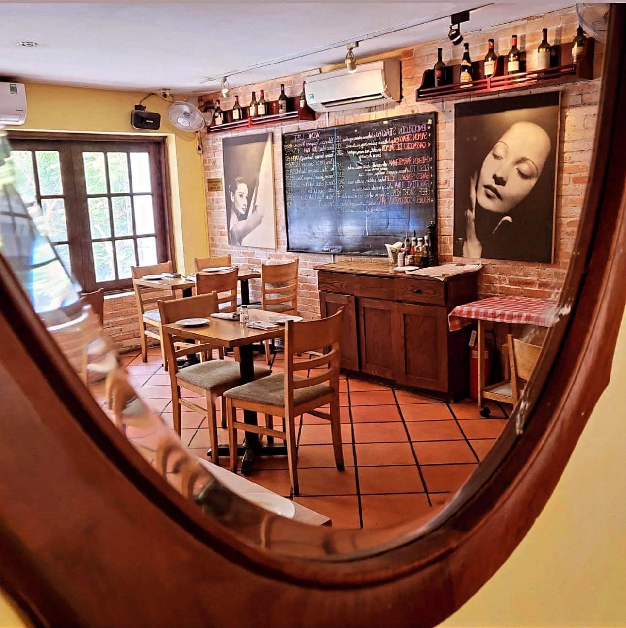 Inside Ciao Bella: brick walls, the daily chalkboard, wood tables