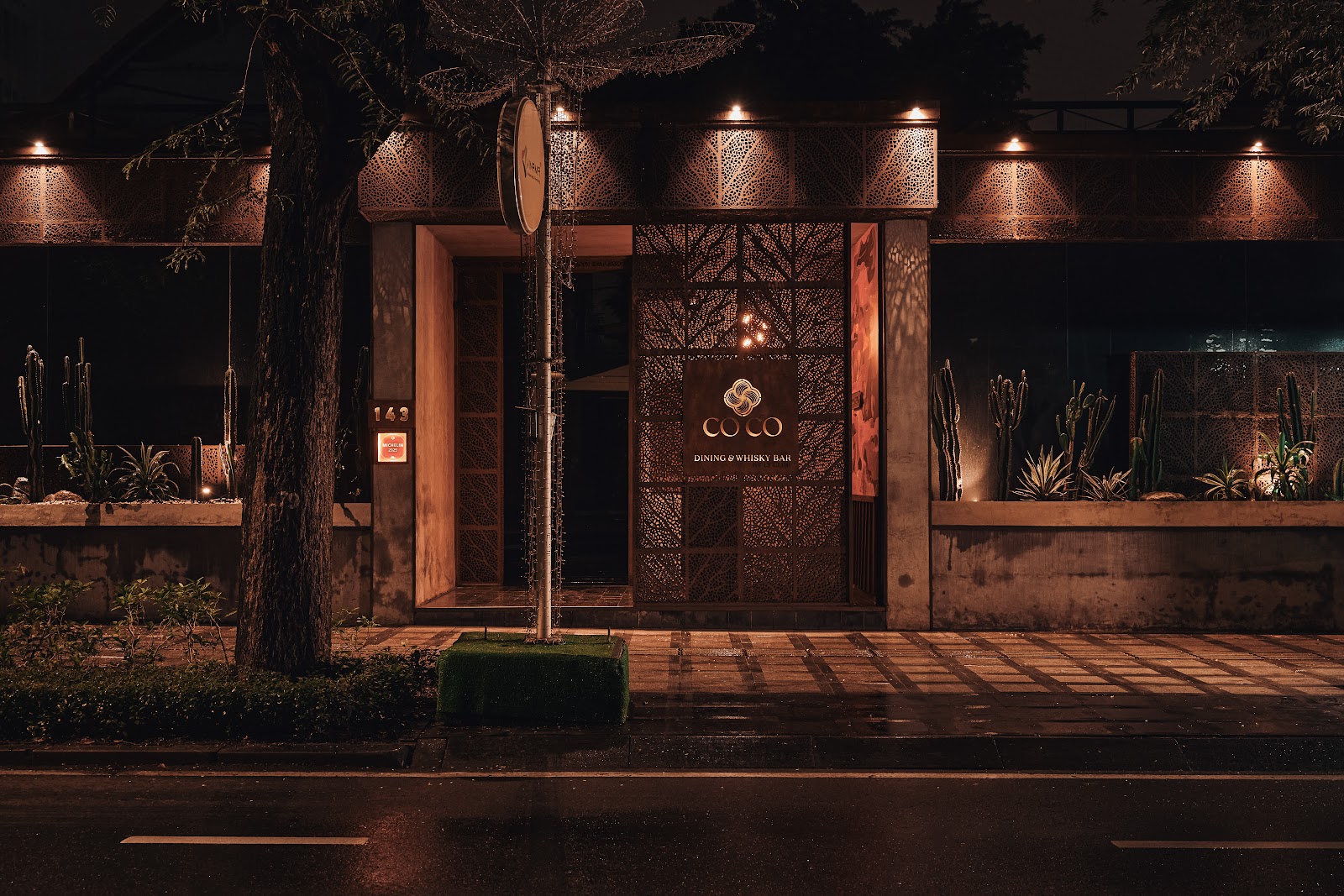 CoCo Dining villa facade at night — number 143 and the COCO Dining & Whisky Bar sign