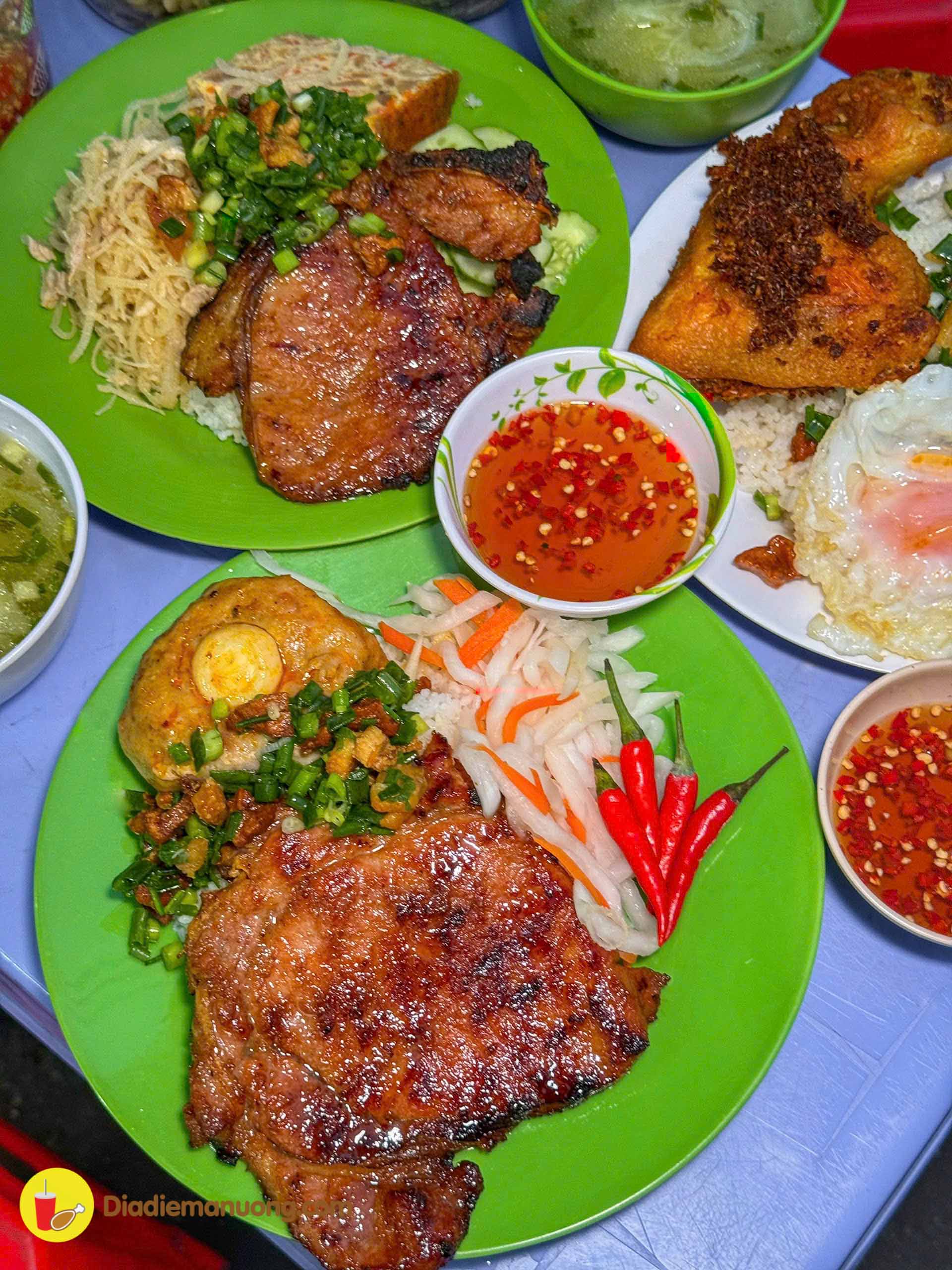 Two plates — rib rice and egg-loaf rice — at the Com Tam Co Giang stall