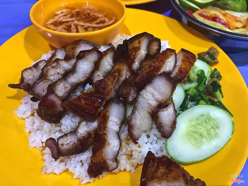 Fried pork belly rice on the yellow plastic plate