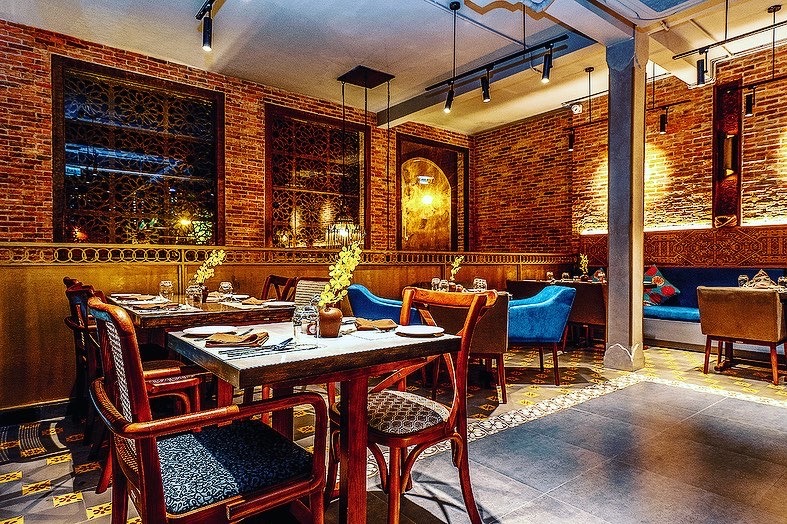 The Dalcheeni dining room — emerald and brass tones