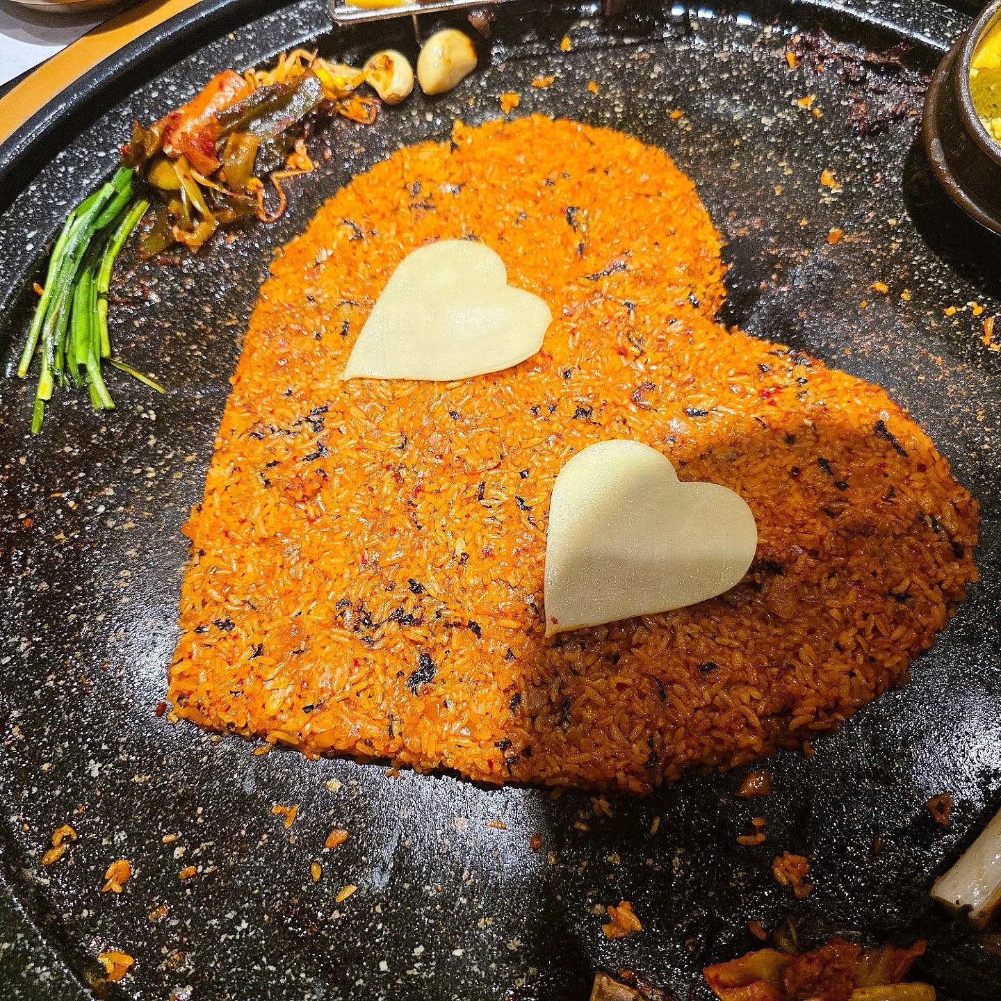 Kimchi fried rice with cheese melting on the stone grill