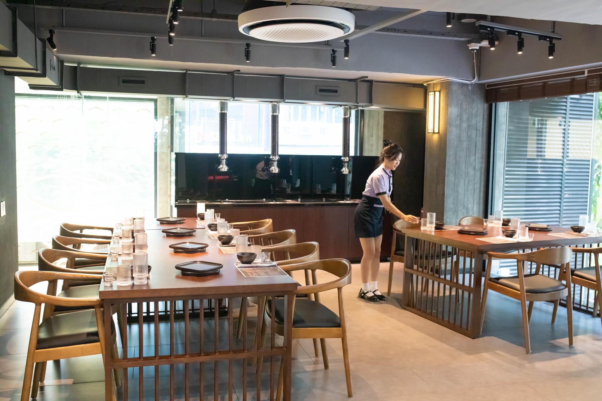 Timber booth tables with grill hoods in the dining room