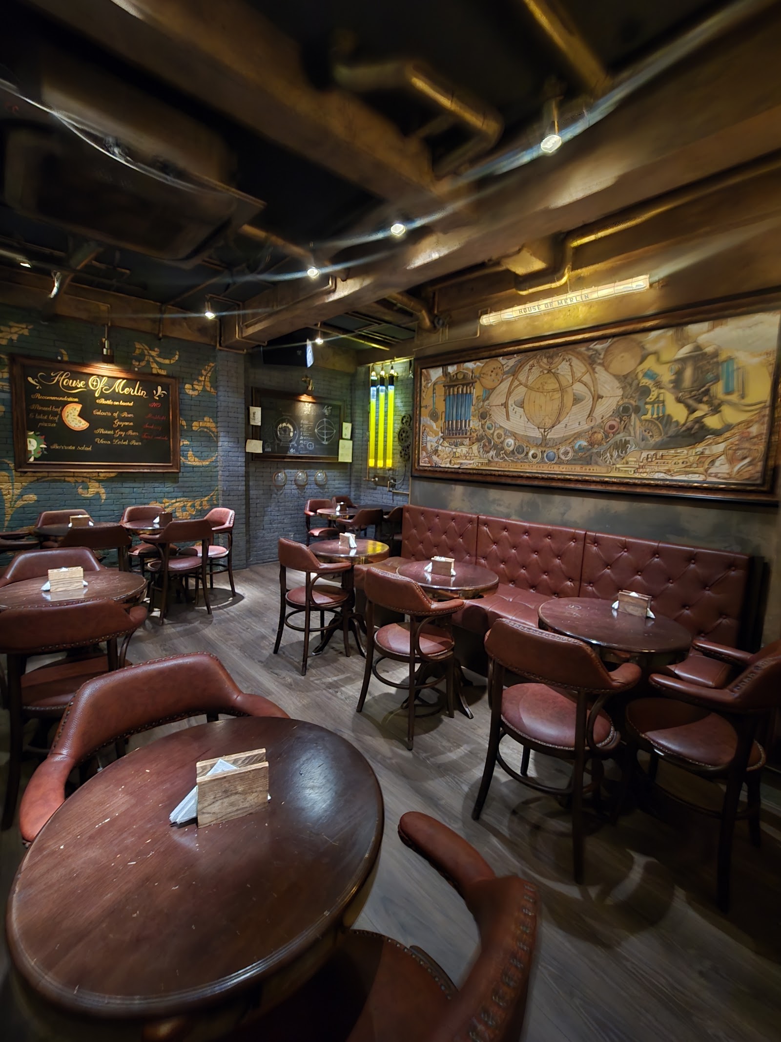 The bar wall — brass rail, backlit bottles, gear detailing