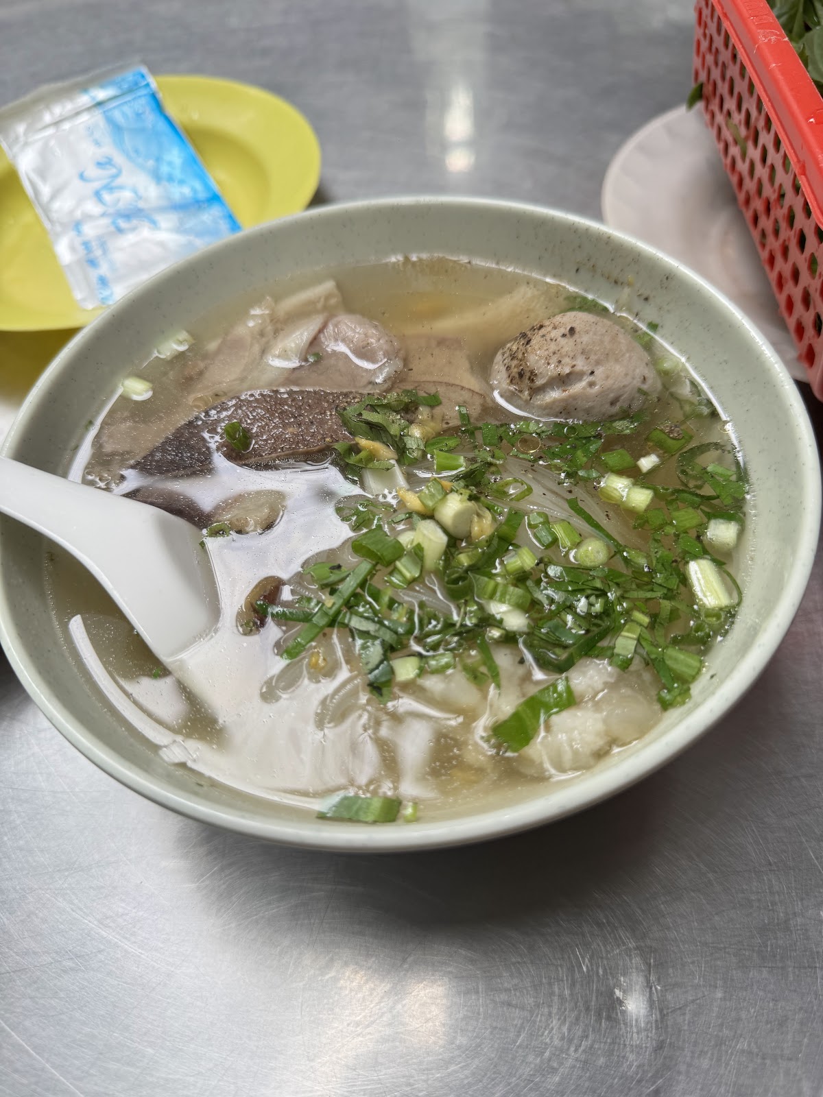 Beef-ball hu tieu up close — clear broth, beef balls, sliced beef — a guest's photo