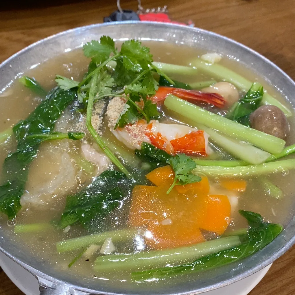 A steaming bowl of noodle soup