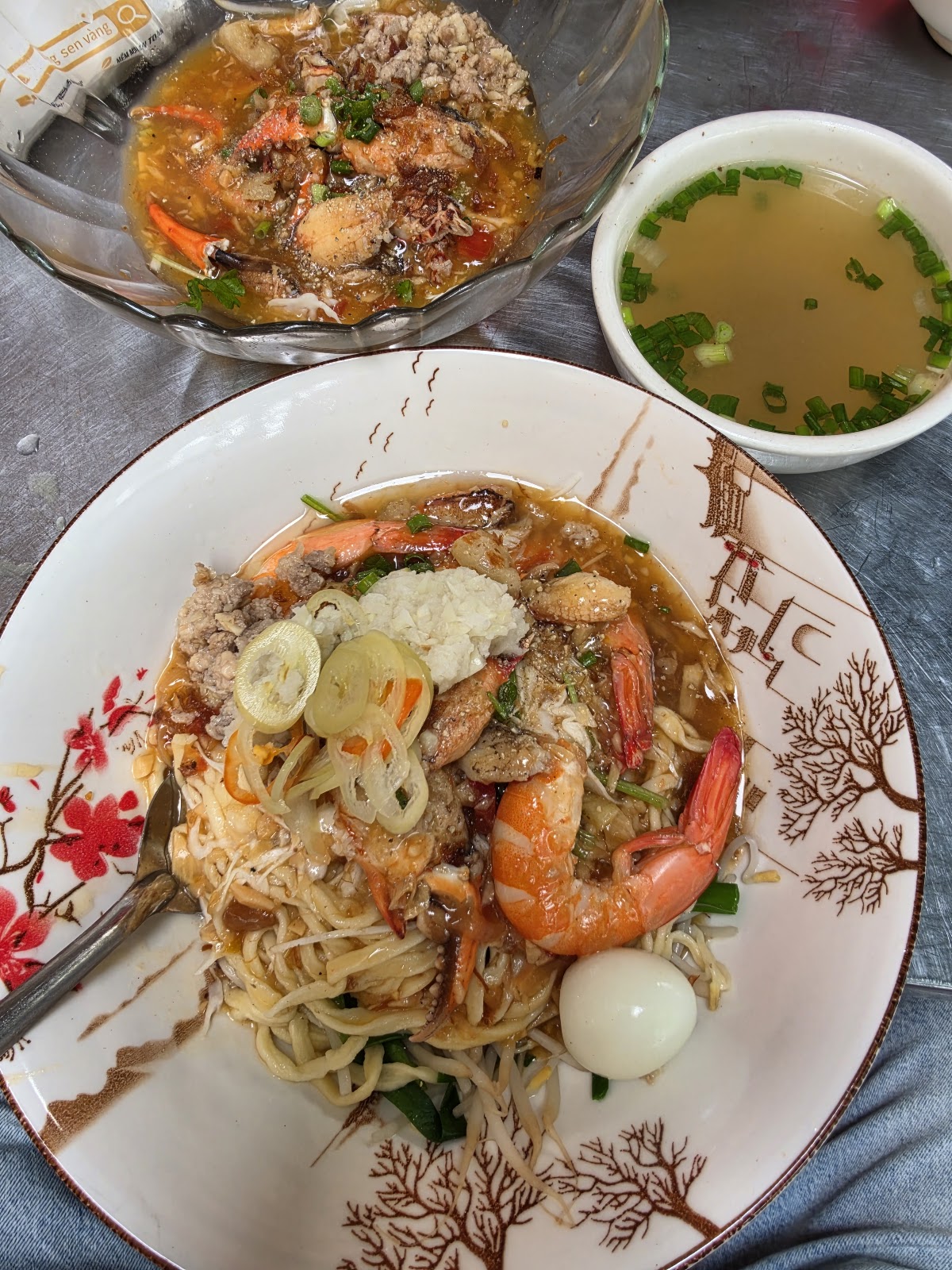 Close-up of the dry hu tieu: fat prawns, dark savory sauce — a guest's photo