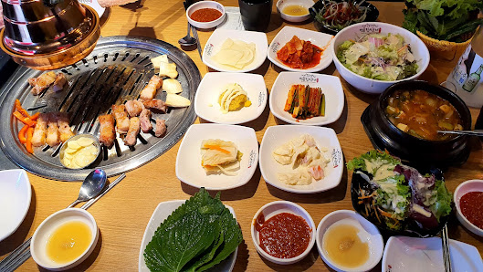 Grilled meat, corn and 10+ banchan bowls on the table