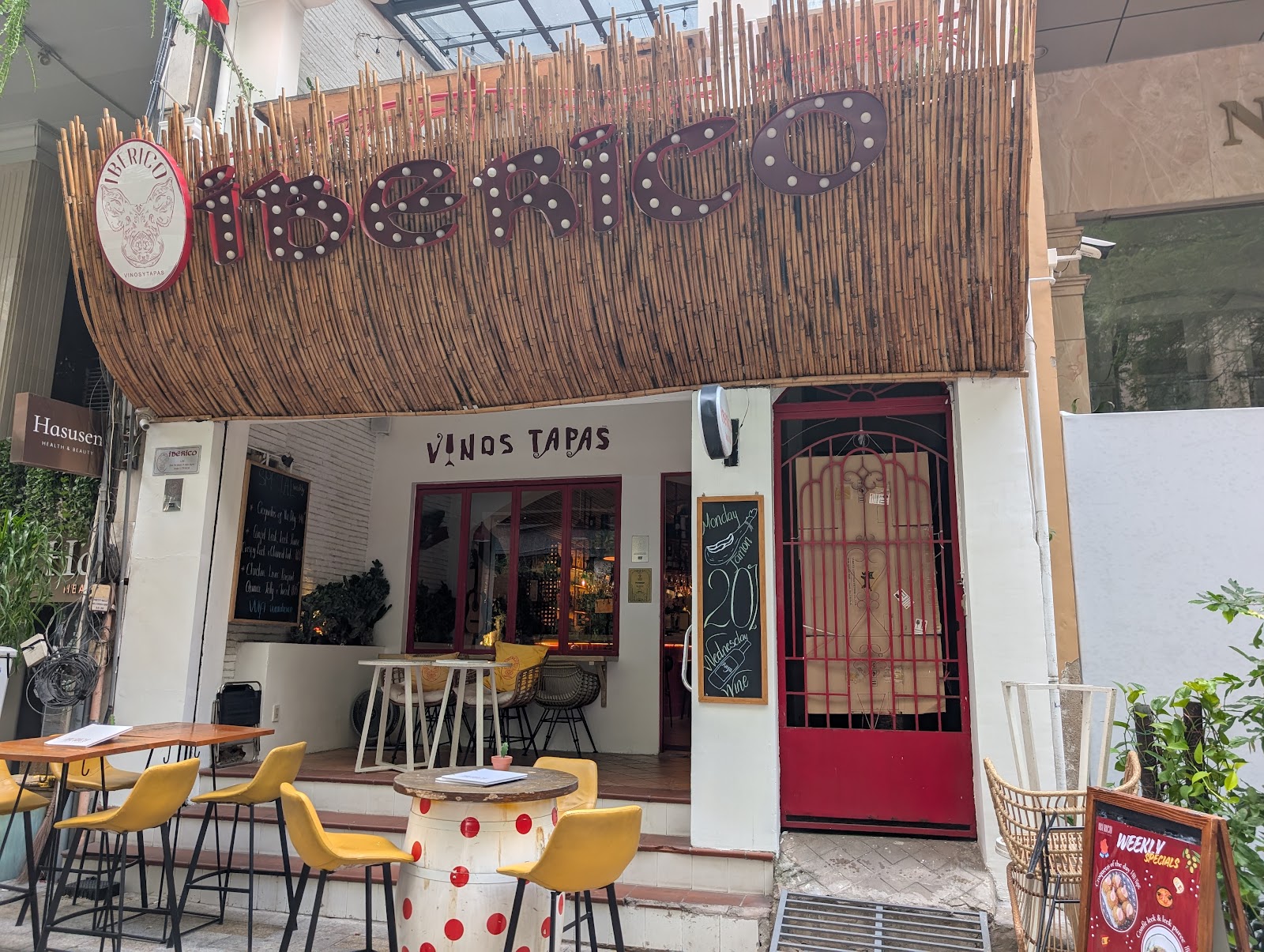 The iBERICO streetfront with bamboo awning and bulb marquee on Thi Sách