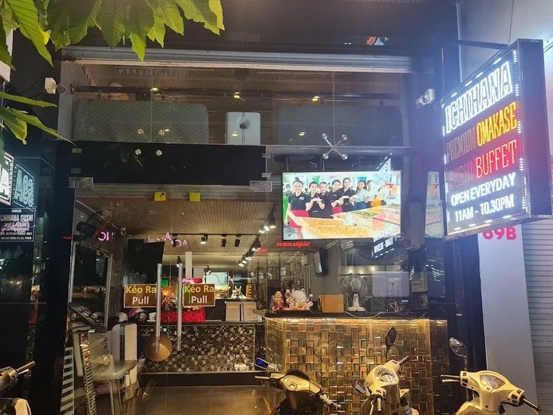 Ichihana's storefront with its neon sign at night