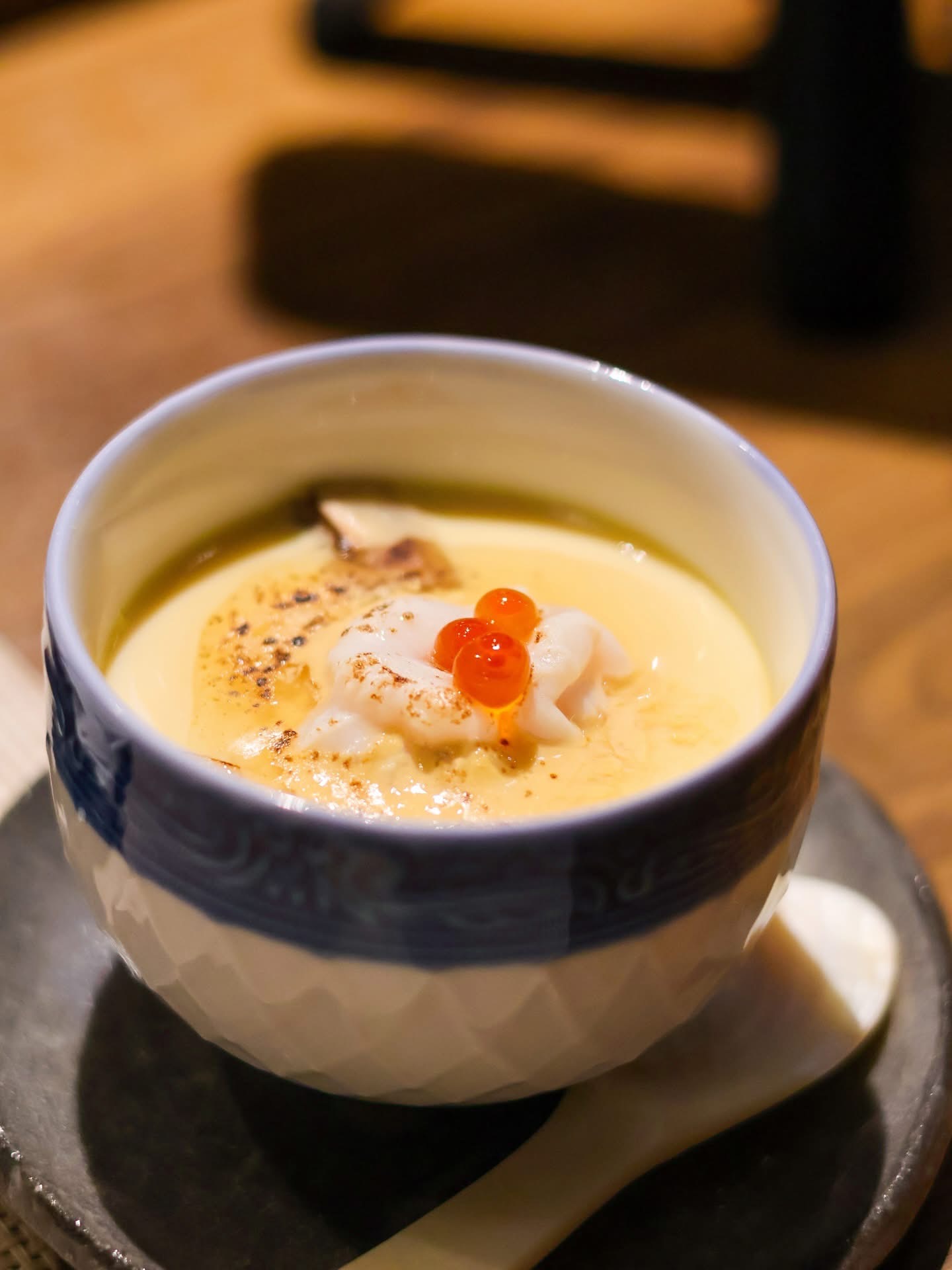 Steamed chawanmushi egg custard with ikura in a porcelain cup