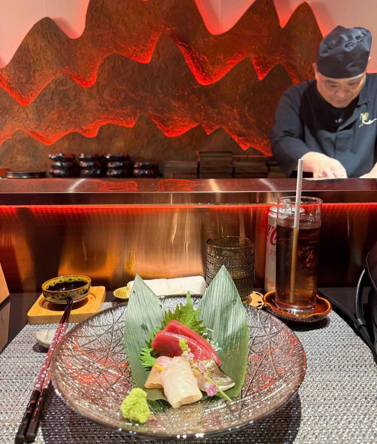 The chef at the counter — the red mountain wall behind