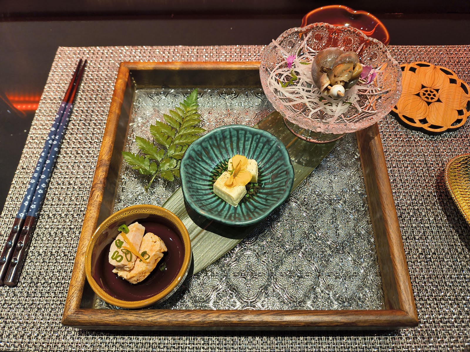 The omakase tray — sashimi, tofu with a flower, small bowls