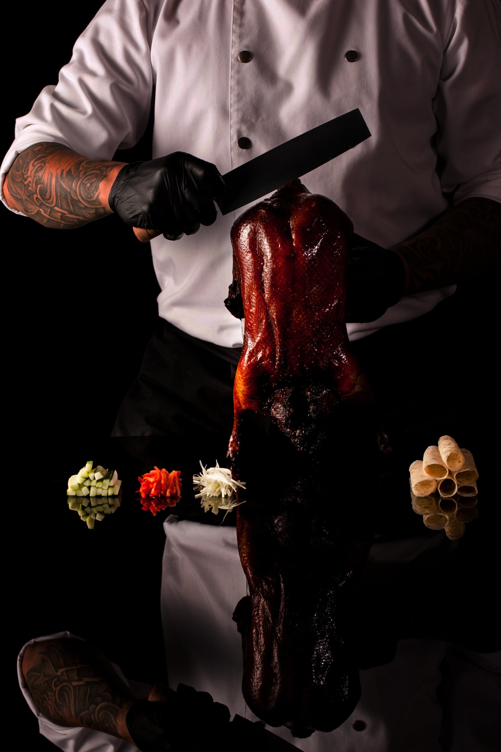 The chef carving Peking duck at the table