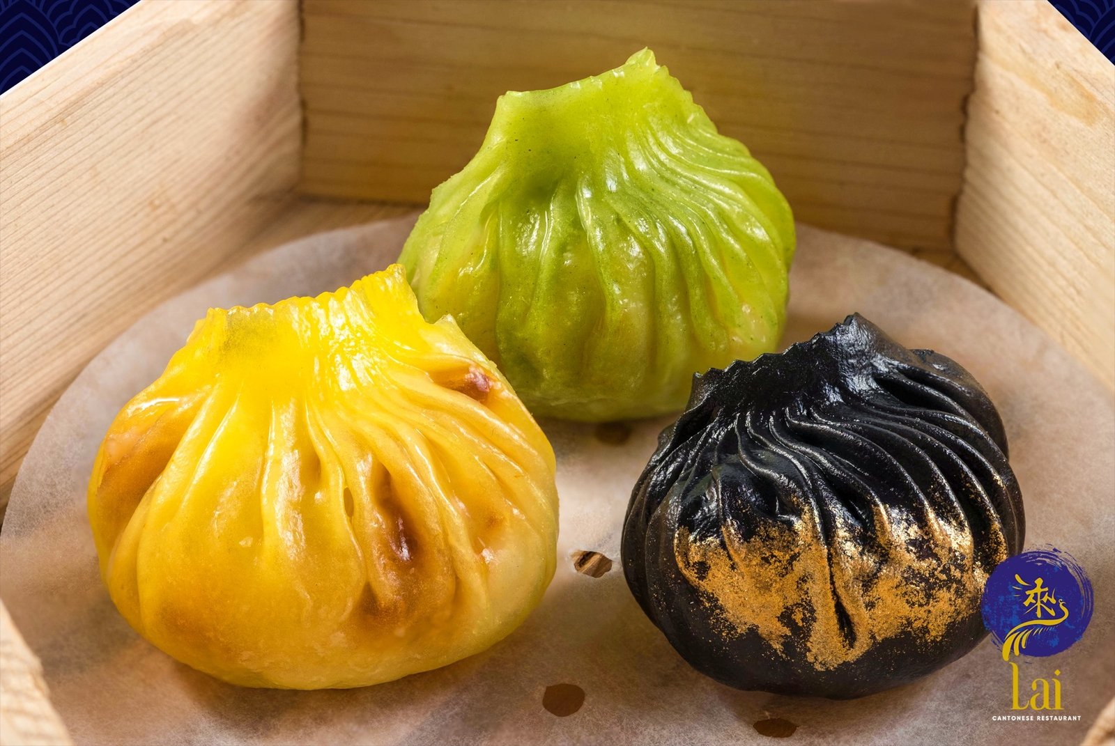 Tri-color soup dumplings — gold, jade, charcoal dusted with gold