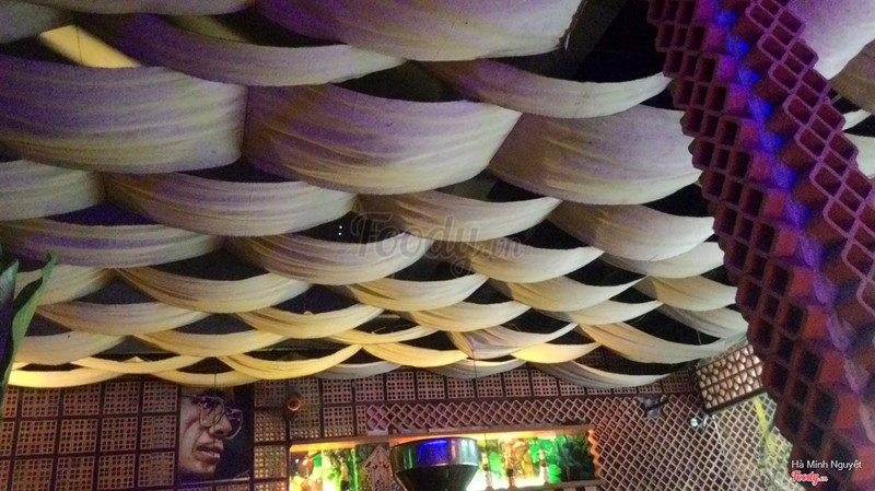 The rippling fabric ceiling over breeze-block brick