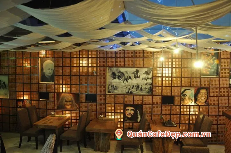 Interior with glowing brick-block walls and musician portraits on the wall