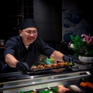 A Mayonaka chef serving sushi at the open counter