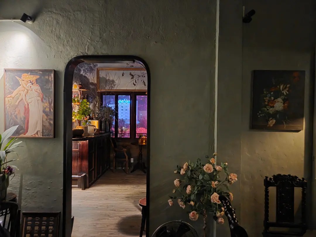 The arched doorway into the room with oil paintings and the night city view