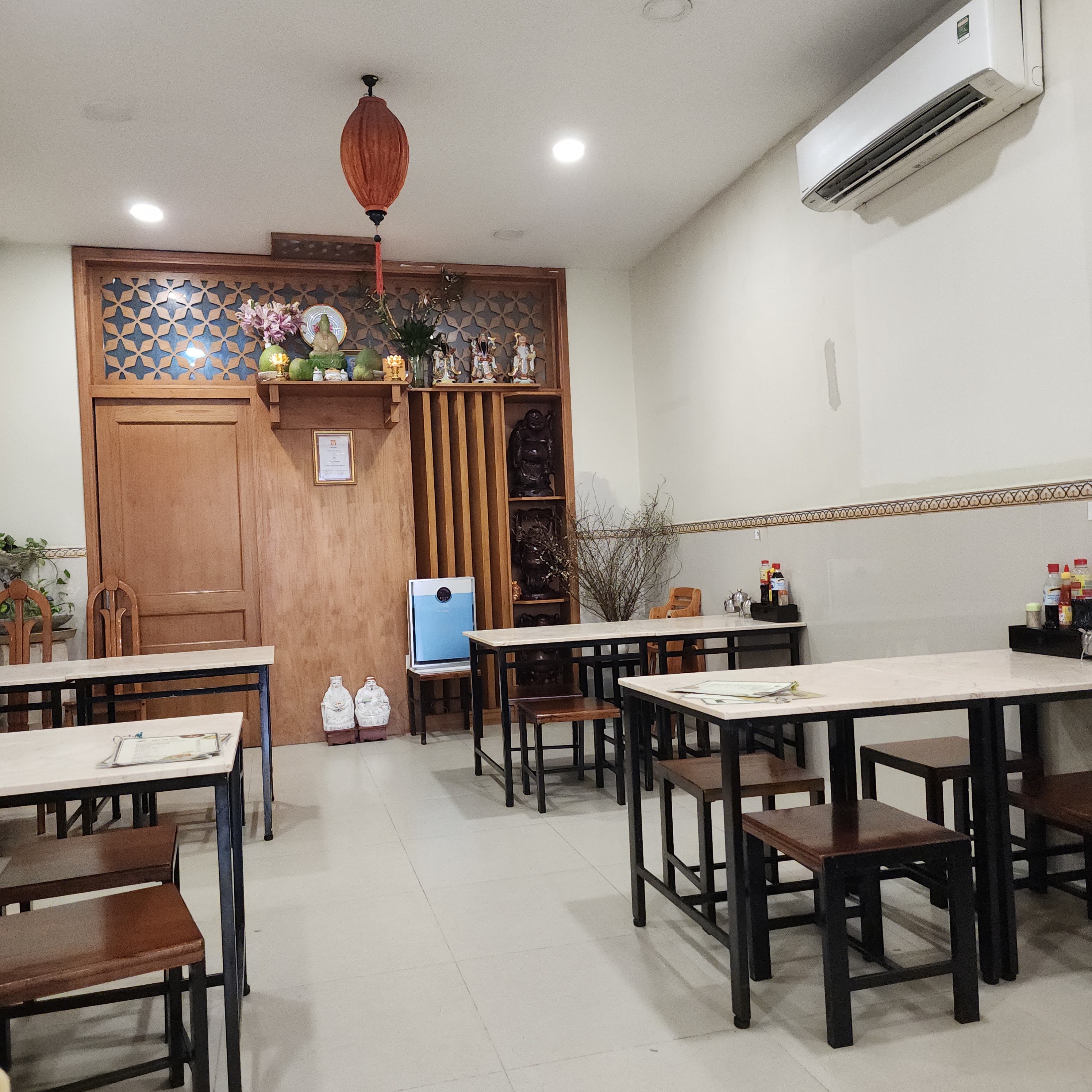 A daytime corner of Mi Chu Tac — wooden tables and slat partitions