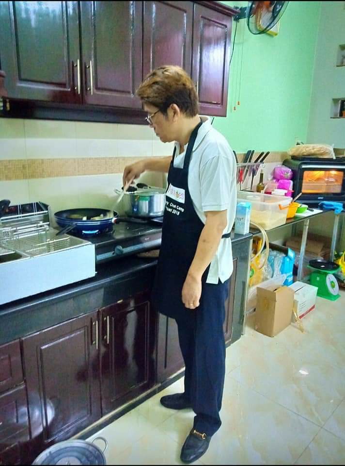 A Hoai cooking in the kitchen