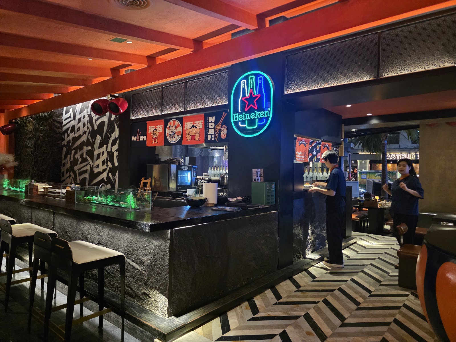 The indoor bar: red beams, kanji wall, neon sign