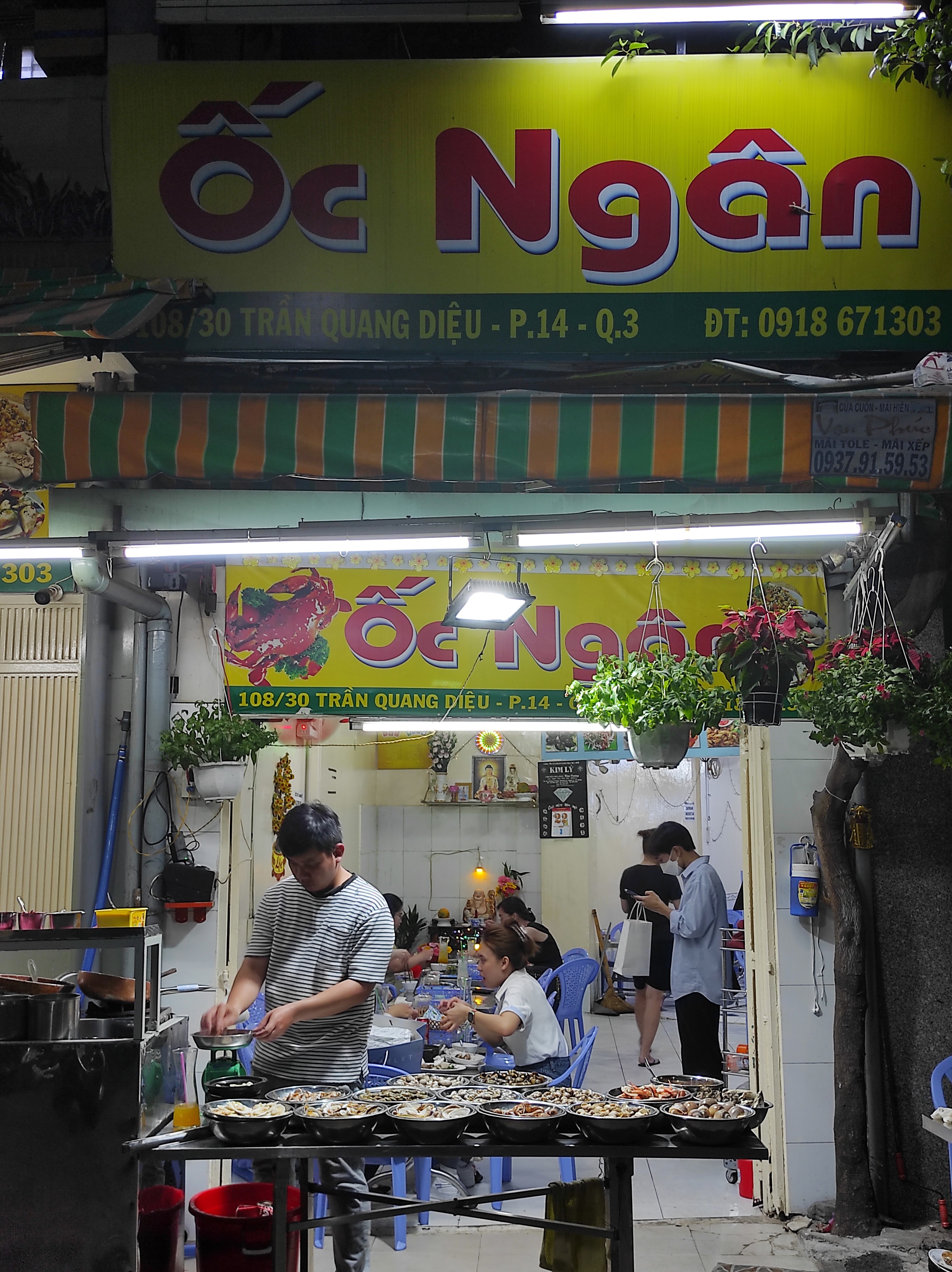 Ốc Ngân's night storefront — 108/30 Tran Quang Dieu, District 3