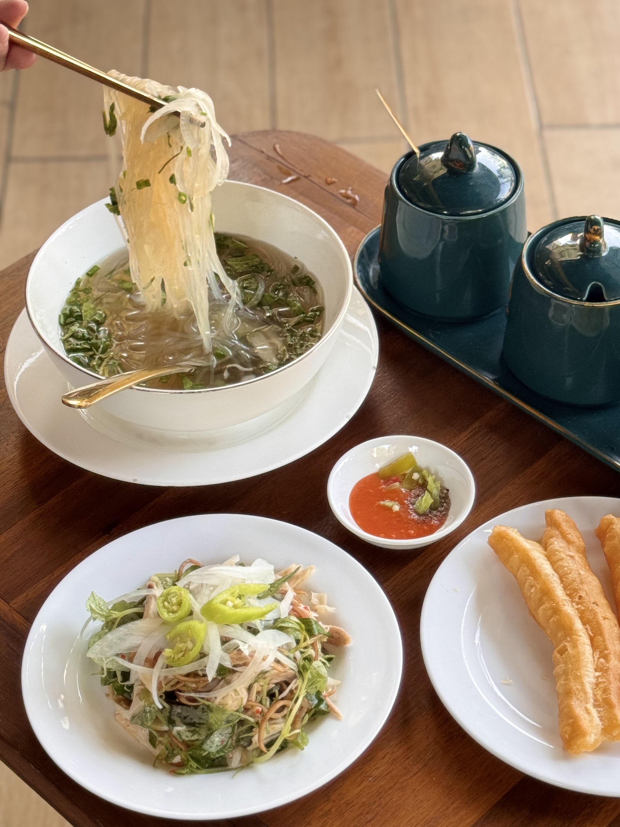 The golden wall and the framed dish strip — Pho Ga Ngo Vang