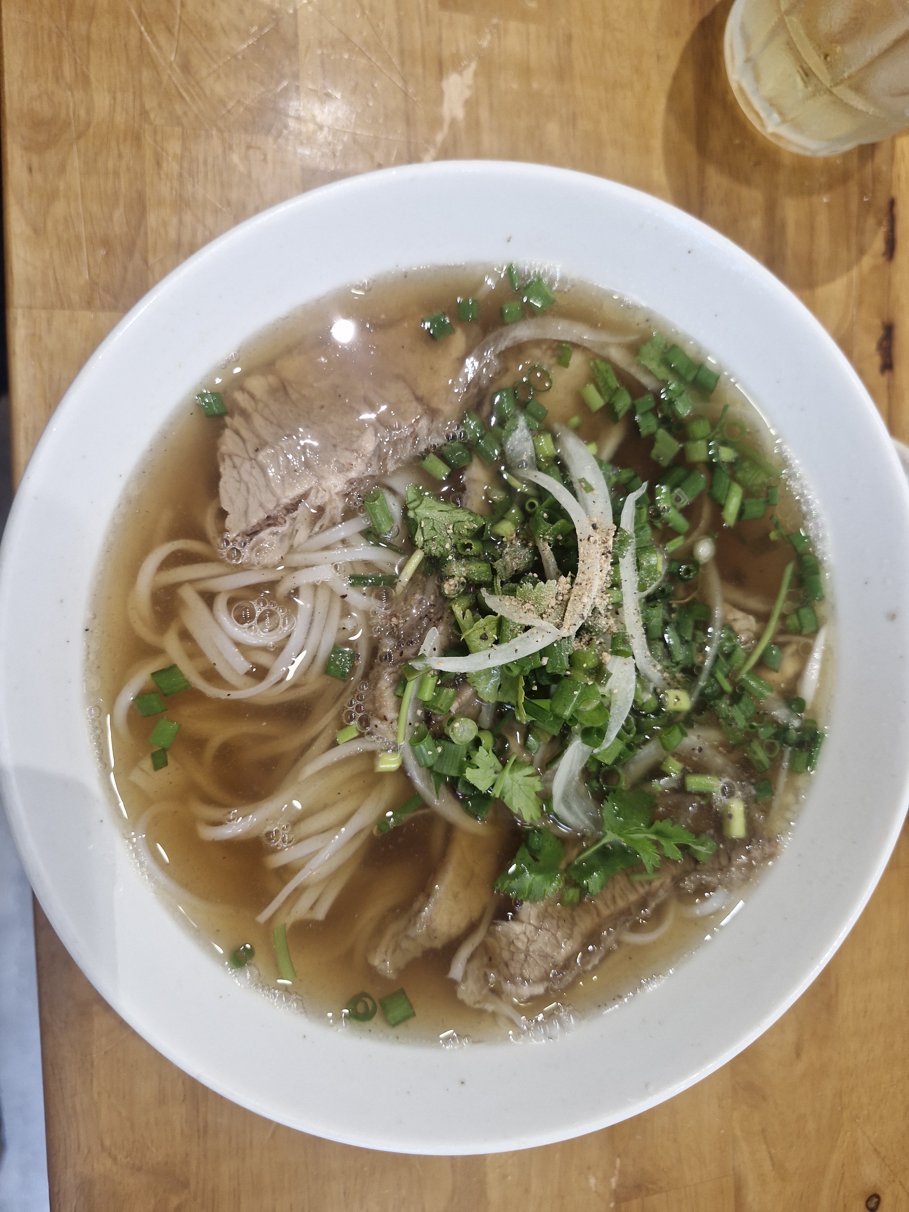 The rare-beef pho bowl — deep broth, tender rare beef