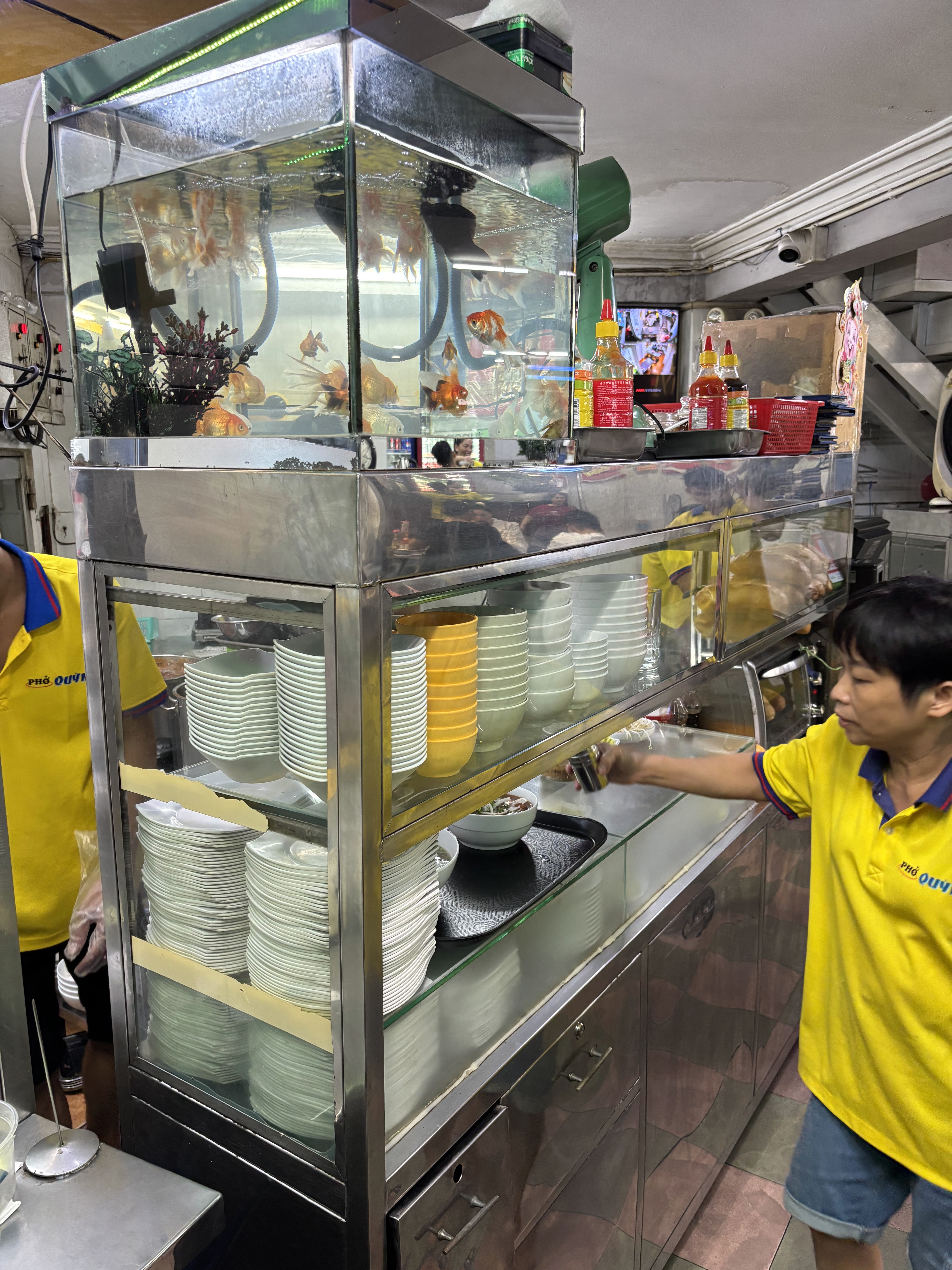 Pho Quynh's bowl cabinet and kitchen, goldfish tank on top