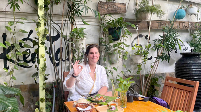 Garden seating with hanging plants and hand-painted signs