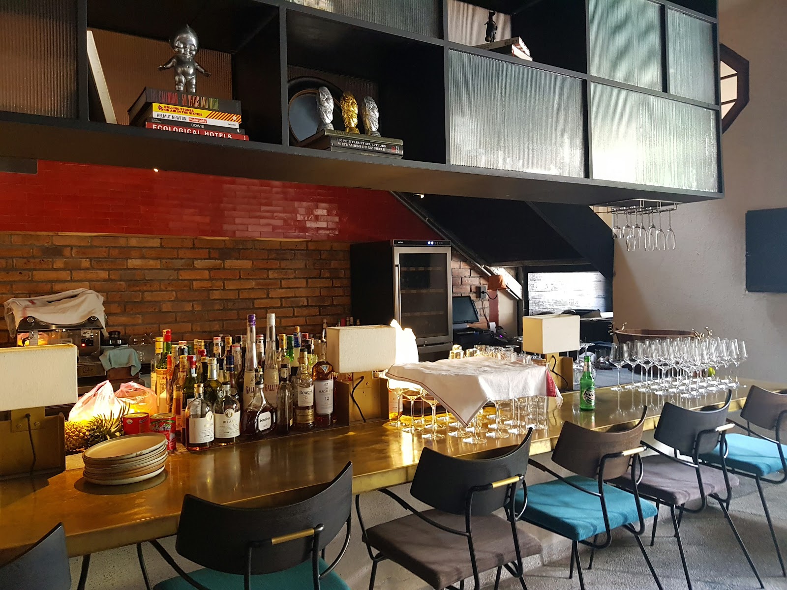 The bar: brass rail, bottle shelves and marble counter
