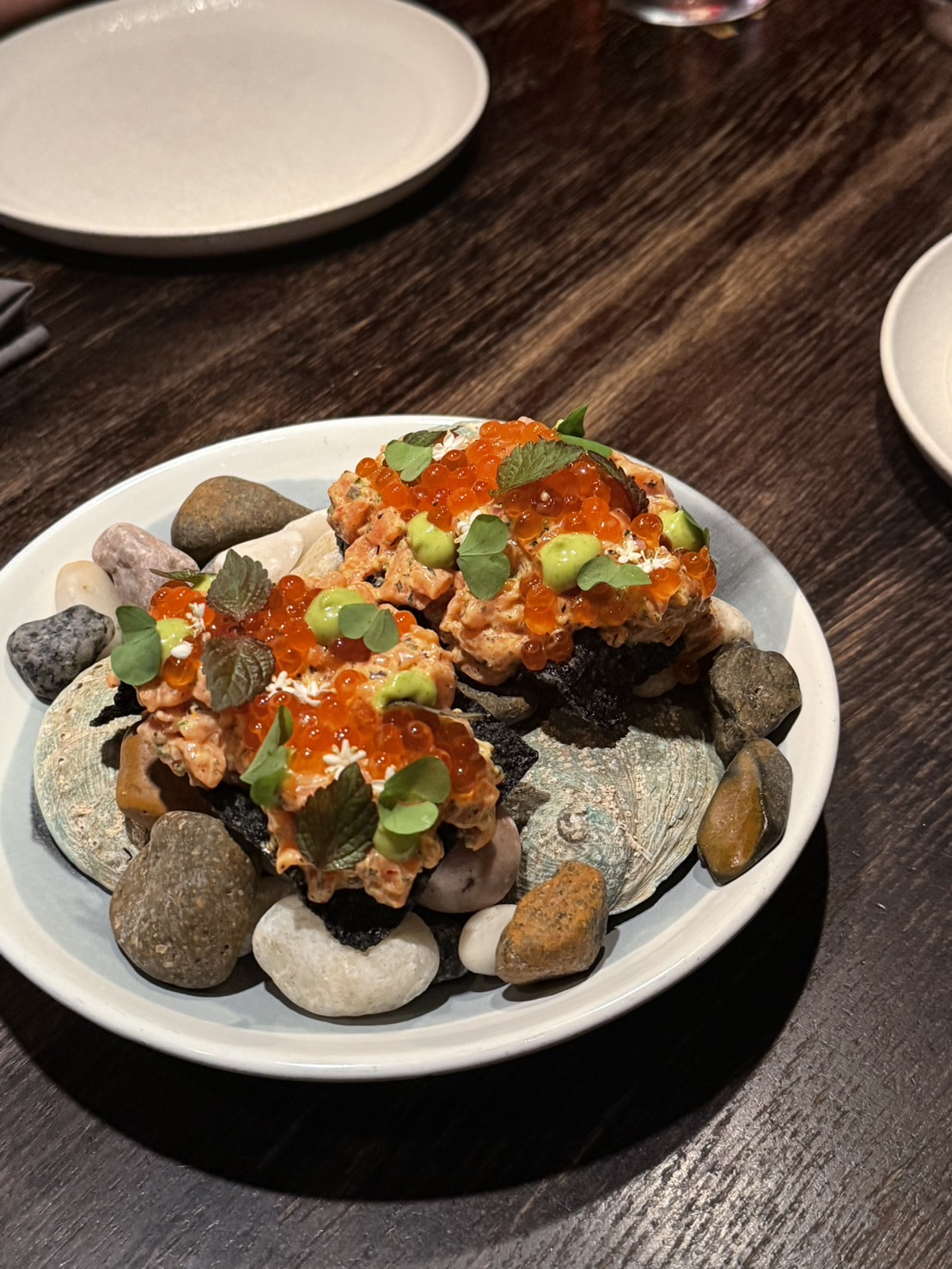 Salmon tartare with roe served on a pebble plate