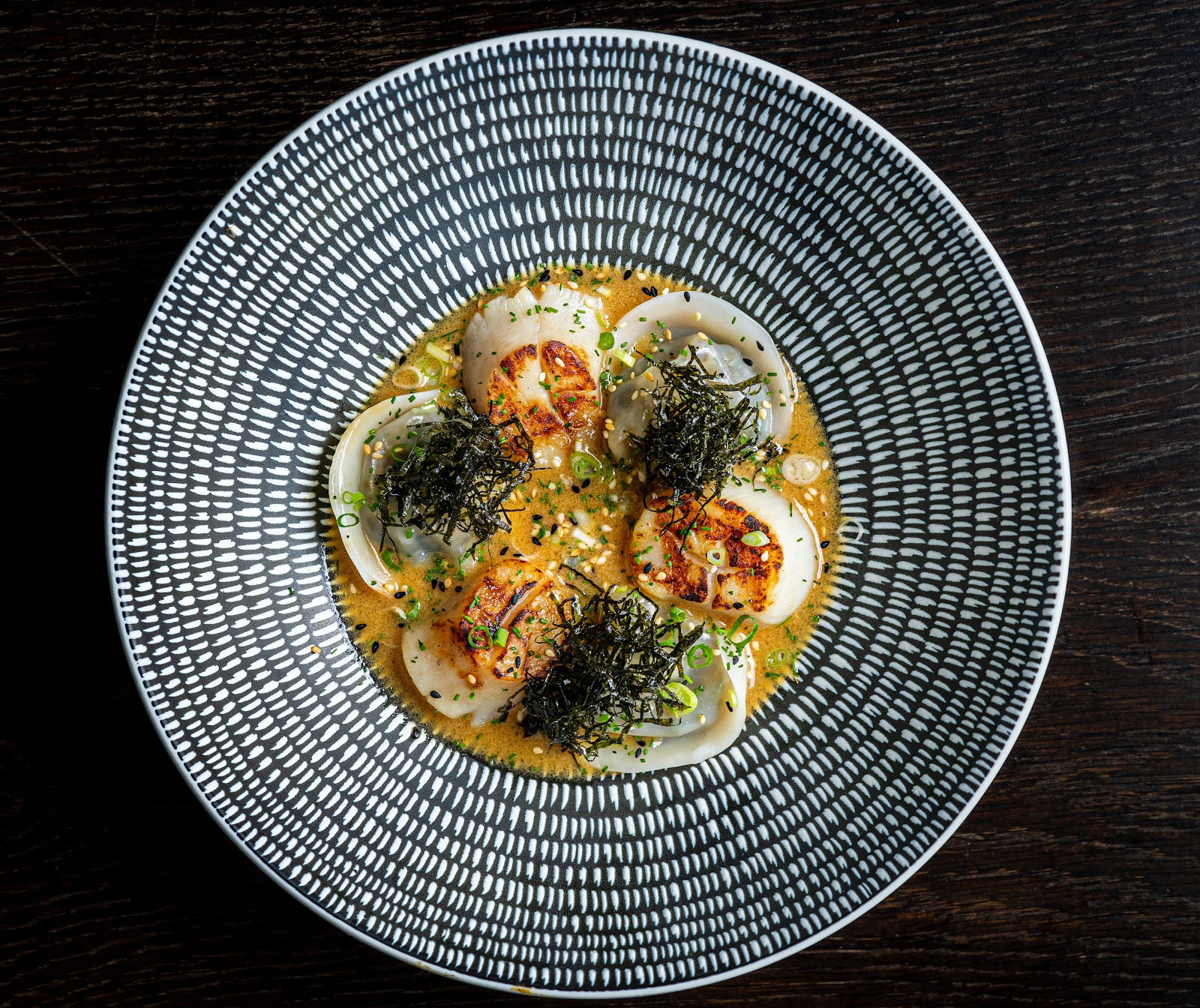 Seared scallops with dumplings in a warm broth