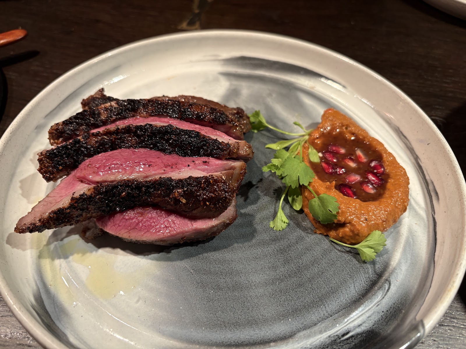 Wood-fired steak sliced, with pomegranate sauce