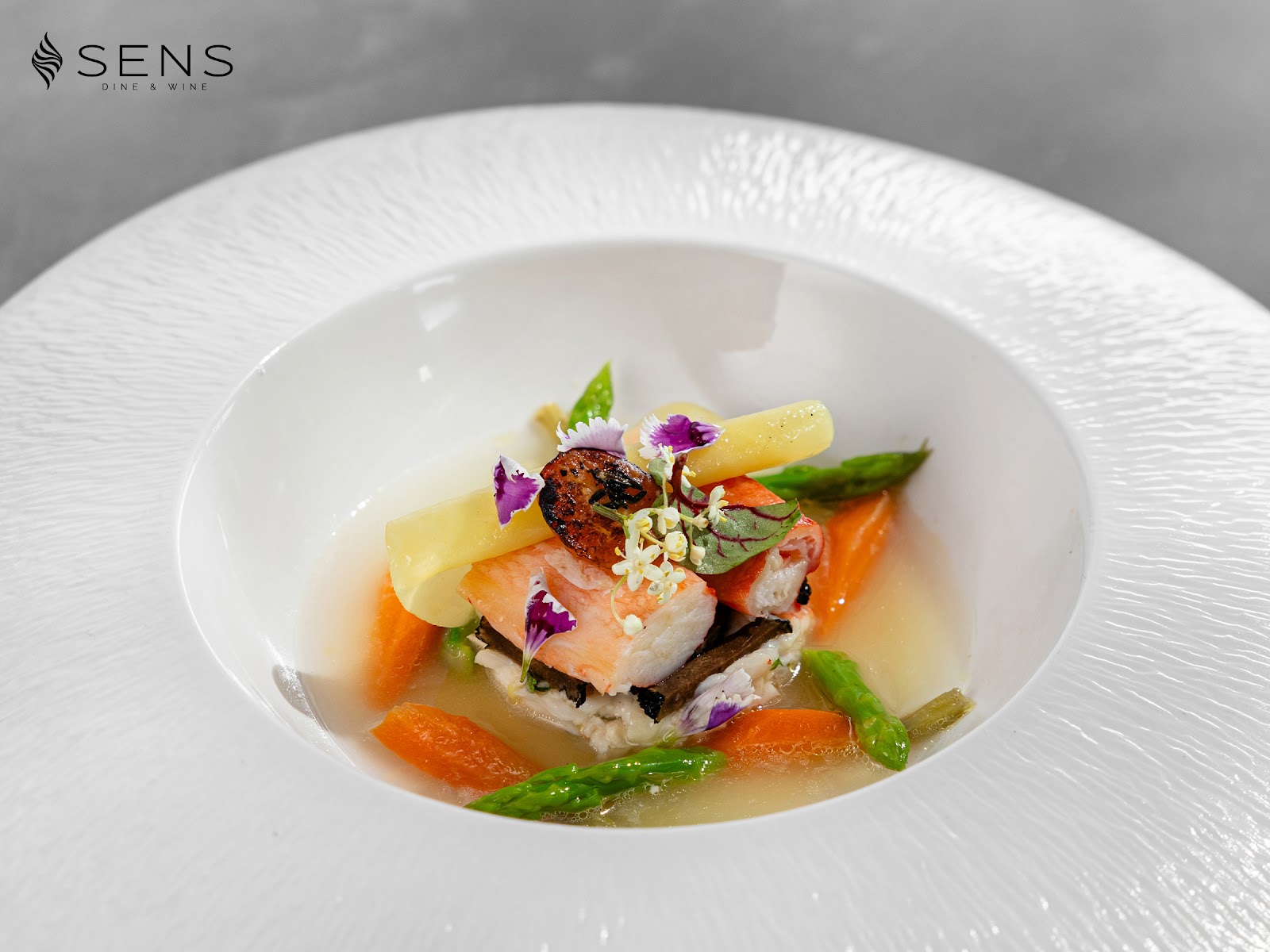 The salmon plate with vegetables and edible flowers