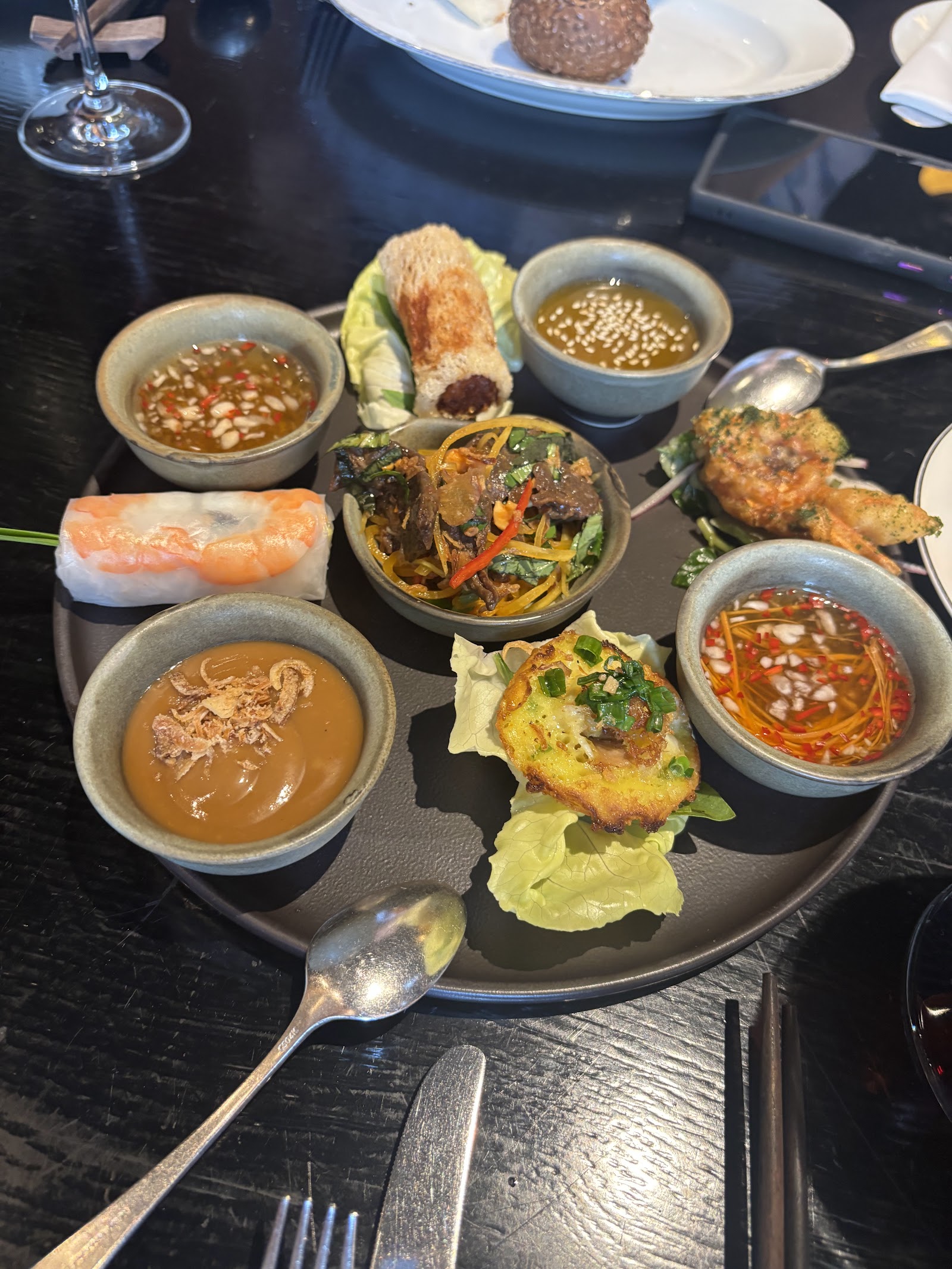 The sharing platter — spring rolls, bánh xèo, dipping sauces and greens — visitor Winnie x's photo, Apr 2026