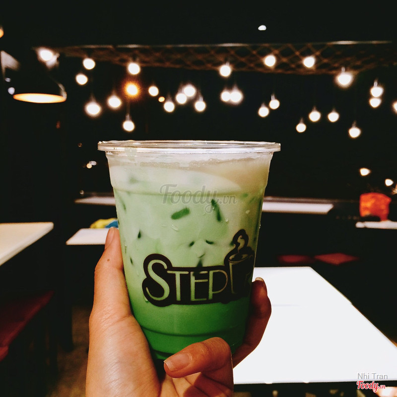 A STEPUP cup against the night bulb ceiling