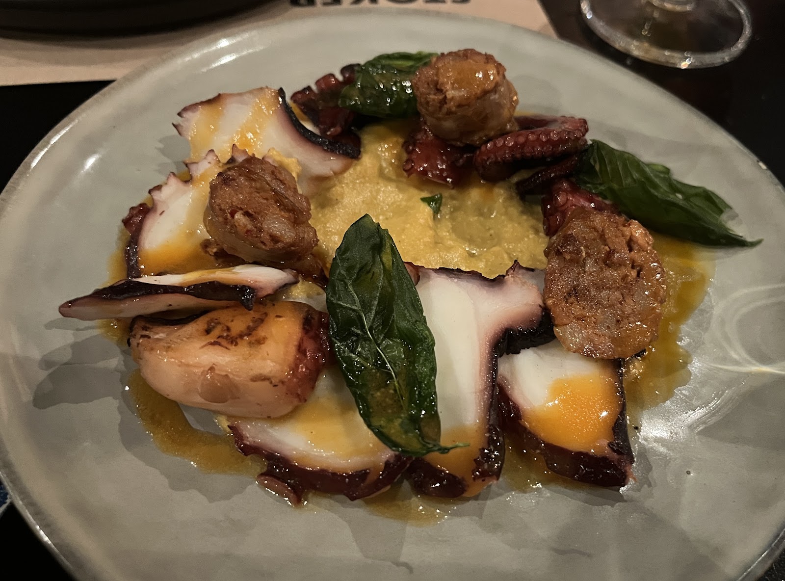 Grilled octopus with chickpeas, basil and golden purée