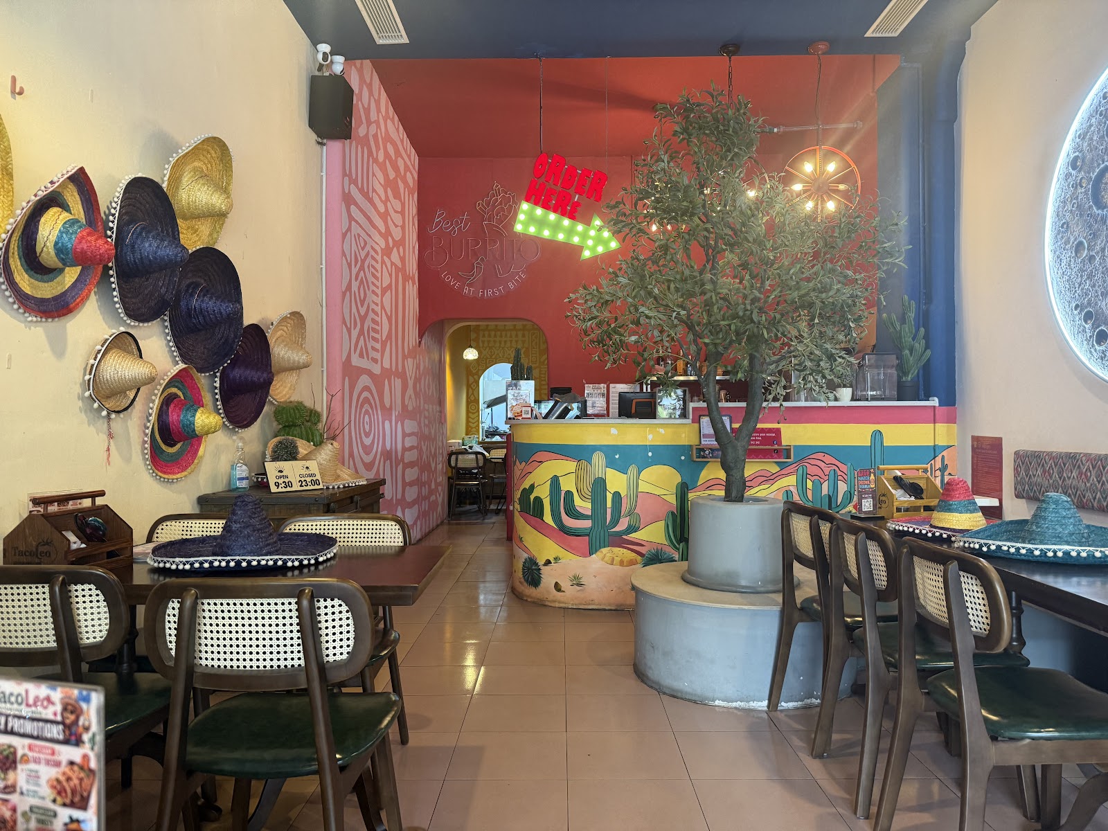 The TacoLeo dining room — the sombrero wall and the cactus-mural order counter
