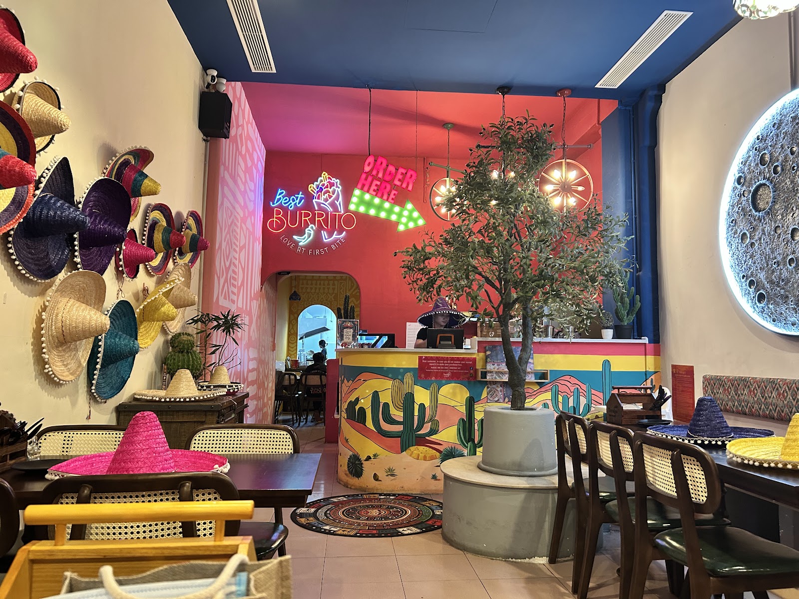 Inside TacoLeo toward the counter — the "Best BURRITO" neon sign