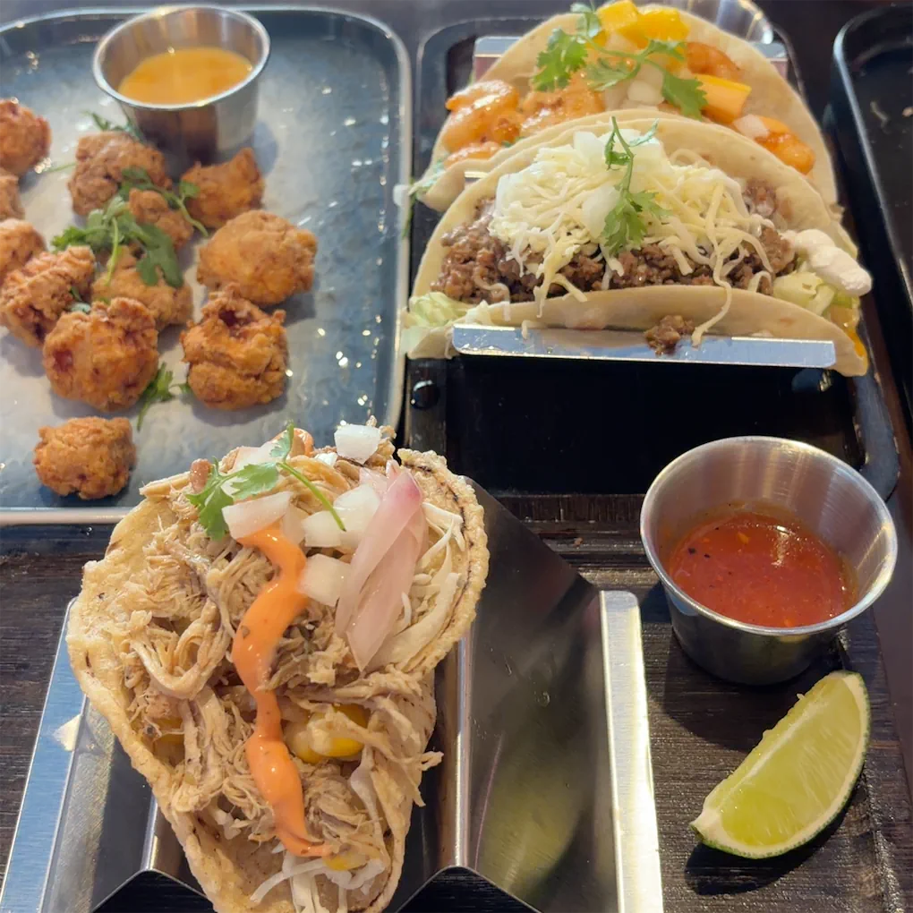 Beef and shrimp tacos with fried chicken bites