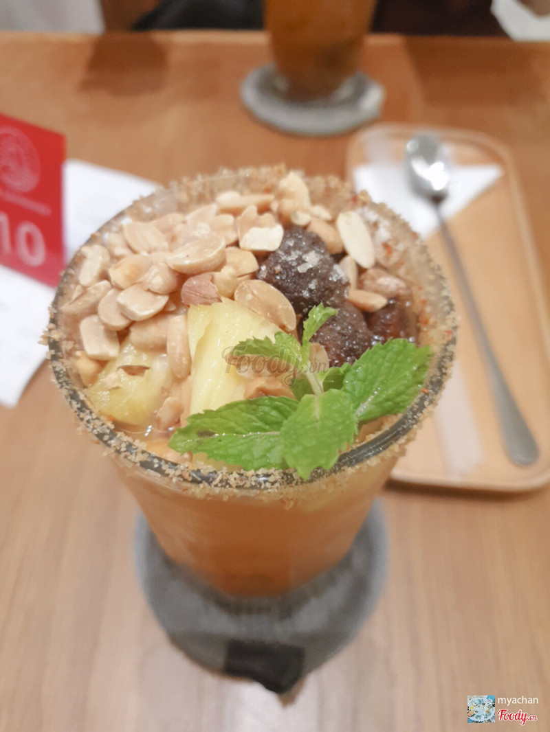 Signature drink close-up: peanuts, pineapple, mint