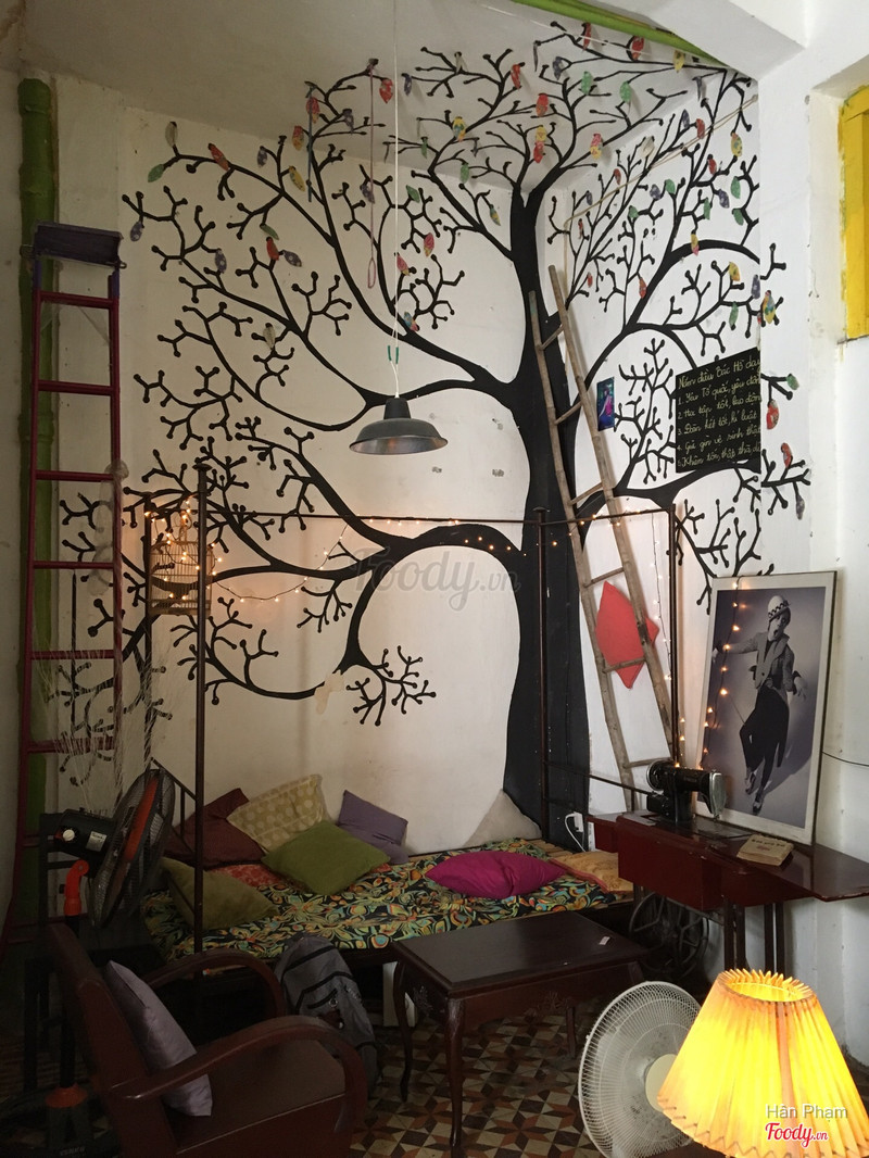Things Café — the tree mural corner by the yellow window frame